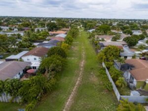 Unopened grassy right of way beside residential properties in Hialeah Florida for a Land Survey
